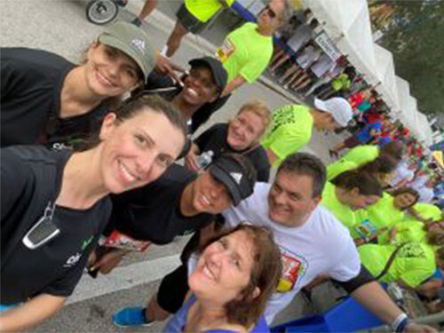 A group of Cinch employees take a selfie preparing to start their run at the 2022 Mercedes-Benz Corporate Run