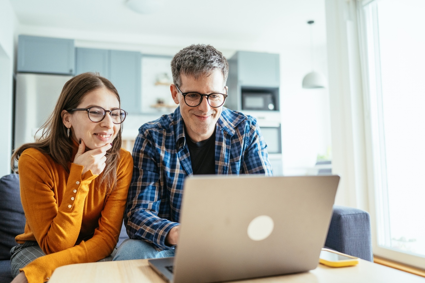 Man and woman looking at computer laptop screen